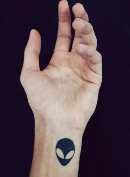 alien tattoo on the wrist