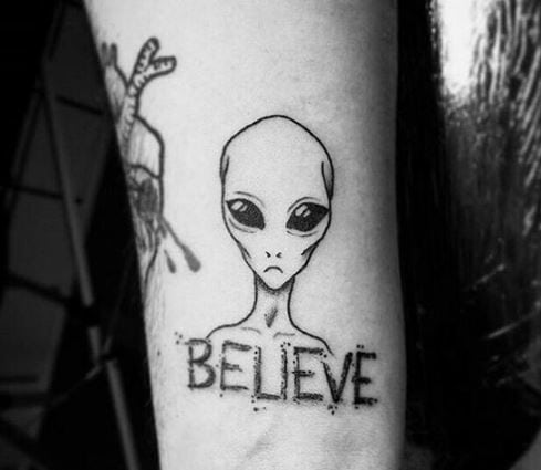 alien tattoo with the word Believe