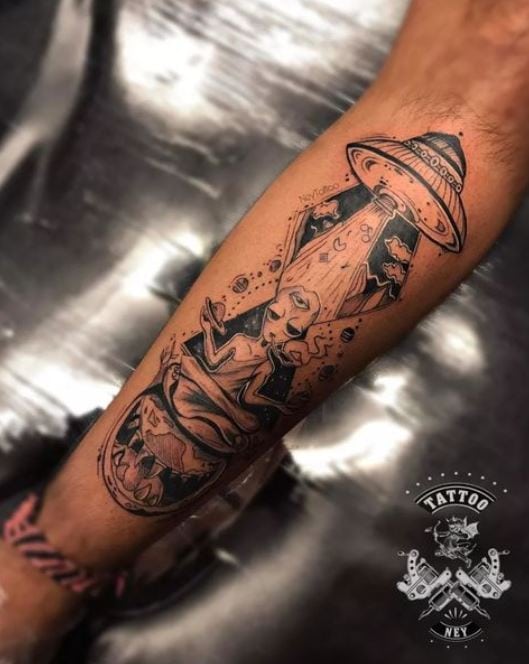 black alien tatoo on the arm
