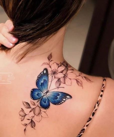 blue butterfly and black flowers tattoo