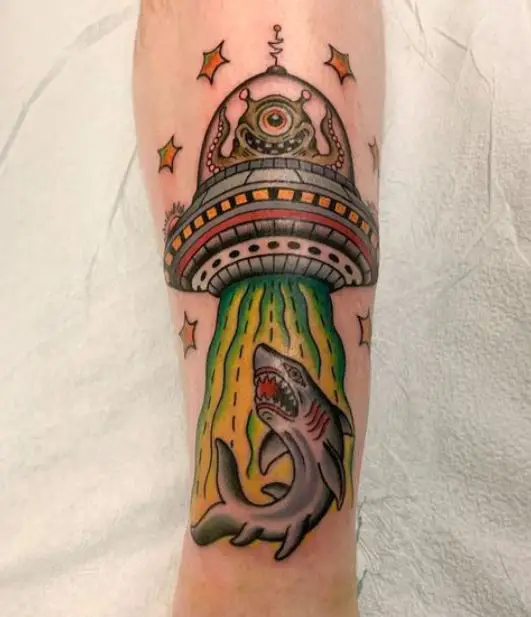 coloured spaceship tattoo with a shark
