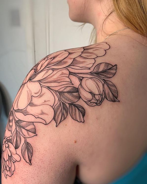 floral tattoo covering the left shoulder