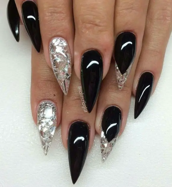 Black stiletto nails with glitter and silver foil