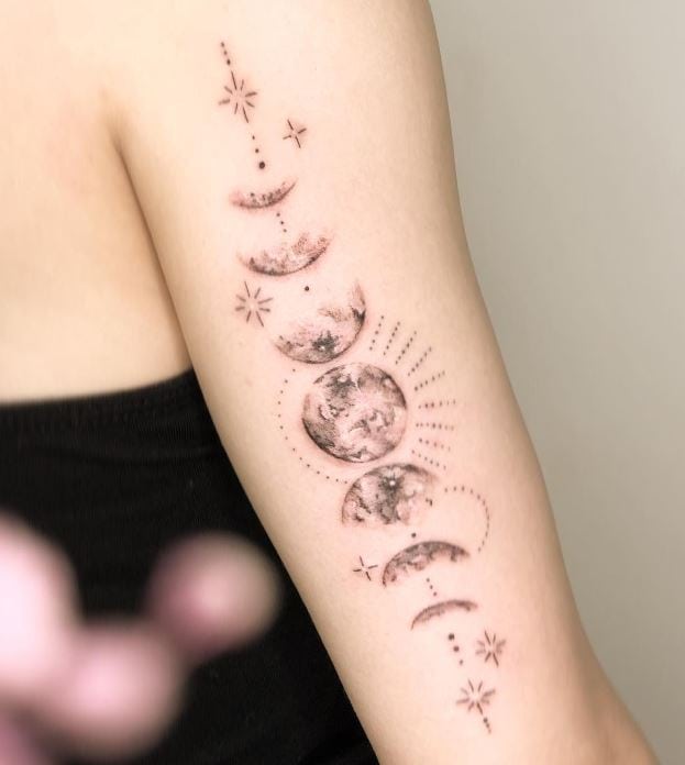 artistic moon phase tattoo