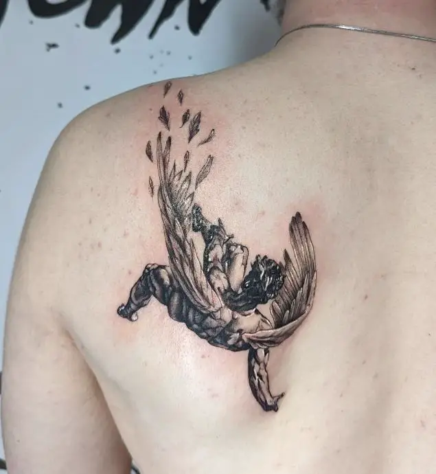 black and grey fall of icarus tattoo