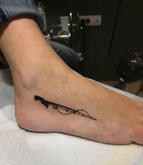 black fishing rod tattoo