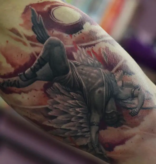 colourful icarus tattoo on the inner bicep