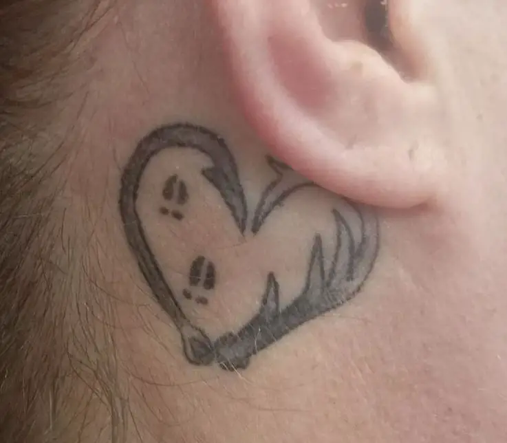 fishing hook tattoo behind the ear