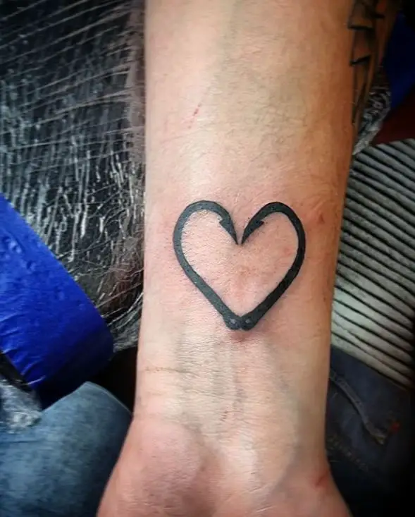 fishing hook tattoo in the shape of a heart