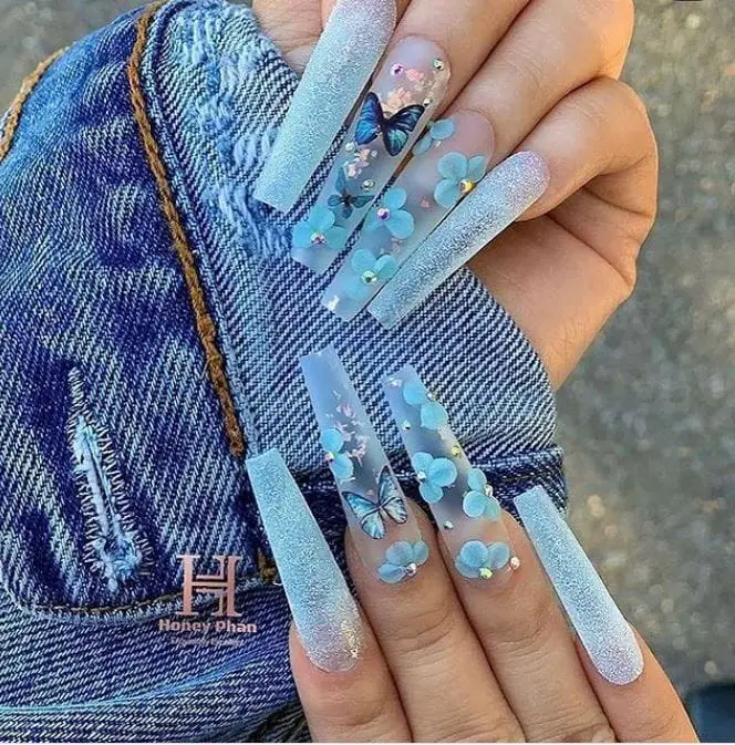 glitter and transparent blue nails with butterflies and flowers