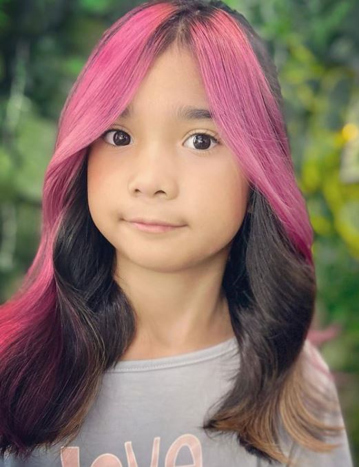 little girl with large pink highlights