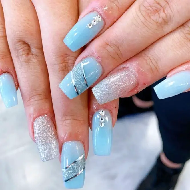 medium length blue nails with glitter