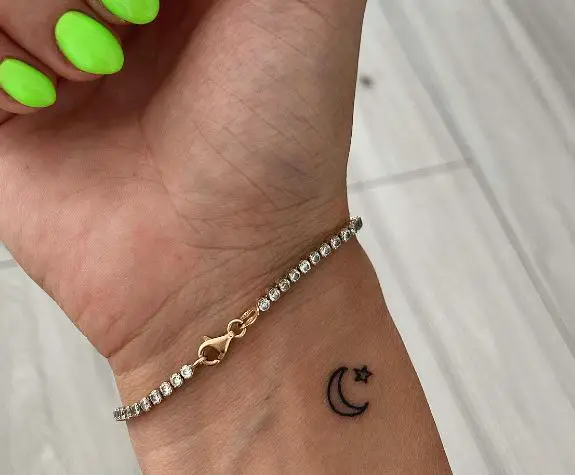 moon and star wrist tattoo