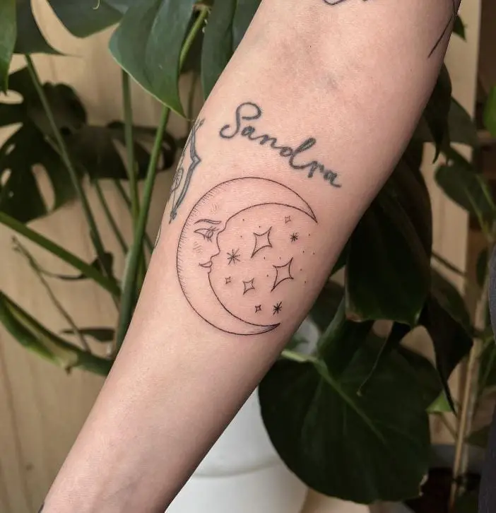 moon tattoo with face and stars