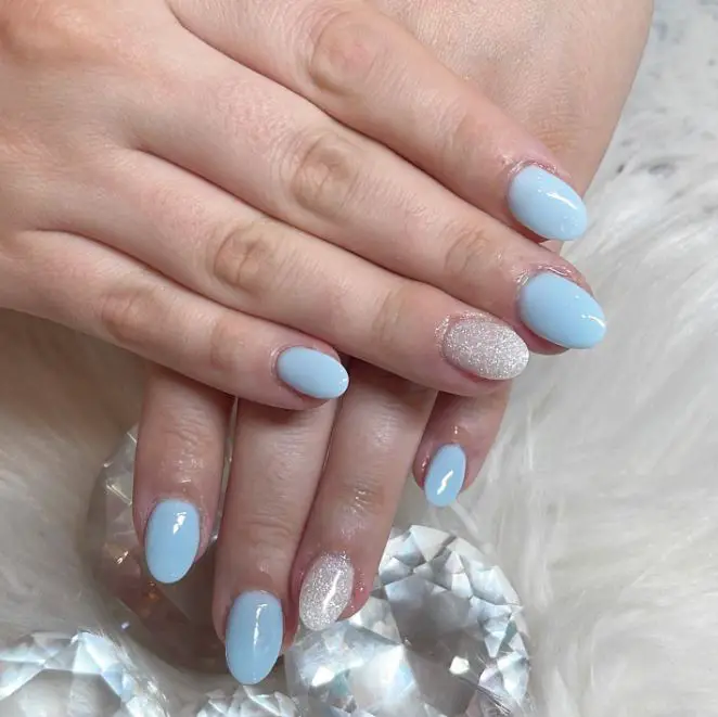 short baby blue nails with glitter accent