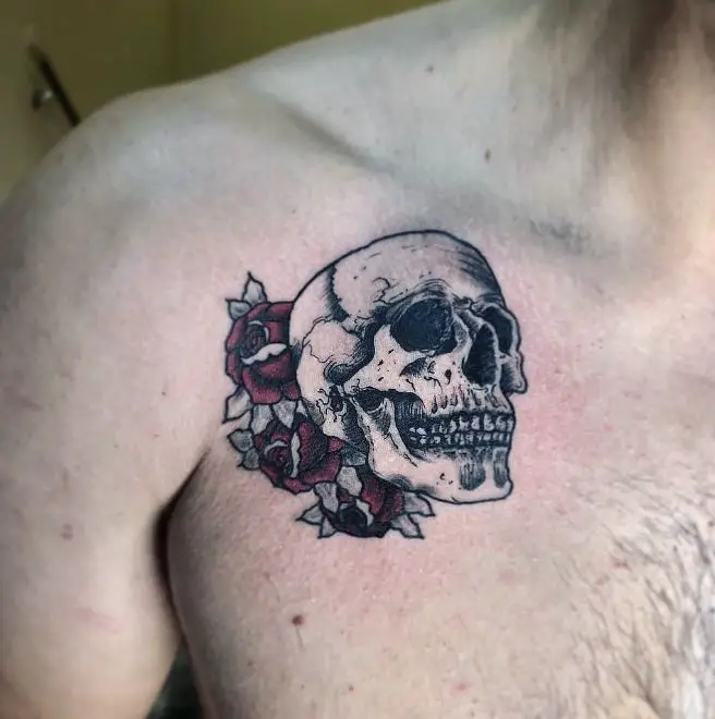 skull tattoo with coloured roses on the shoulder