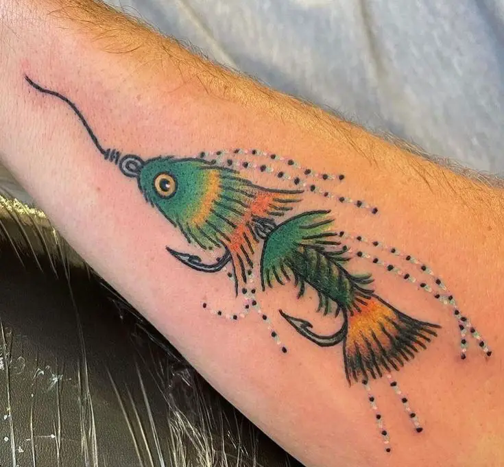 tattoo of a fish caught in a fly fishing hook