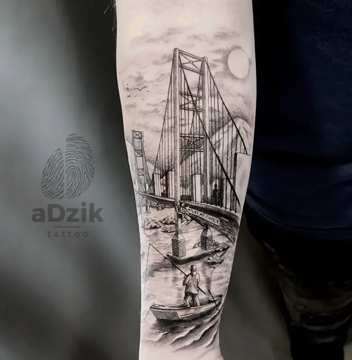 tattoo of a person fishing on a boat near a bridge