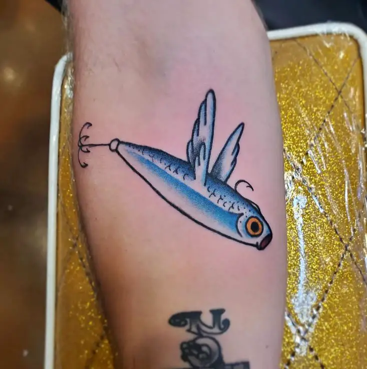 tattoo of a tuna caught in a fly fishing hook