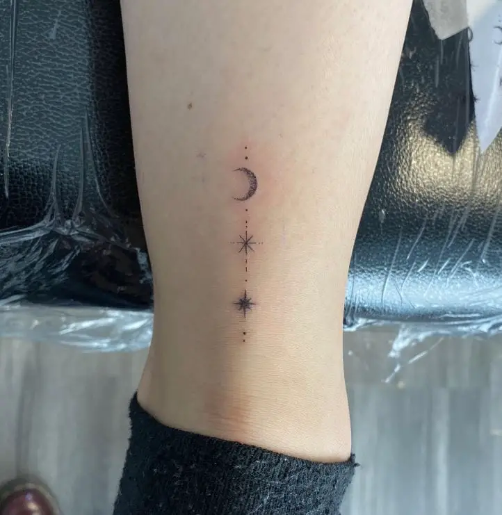 vertical tattoo with moon and stars
