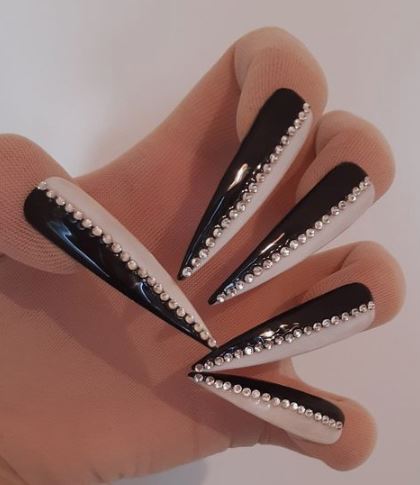 white and black nails with center-lined silver stones