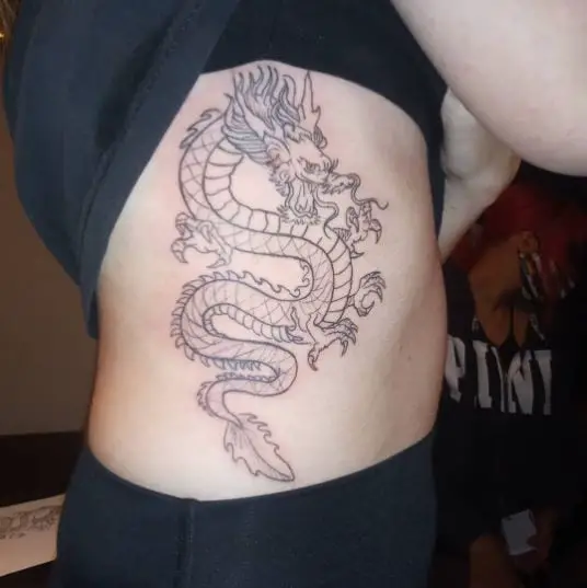 Black Line Japanese Dragon Rib Tattoo