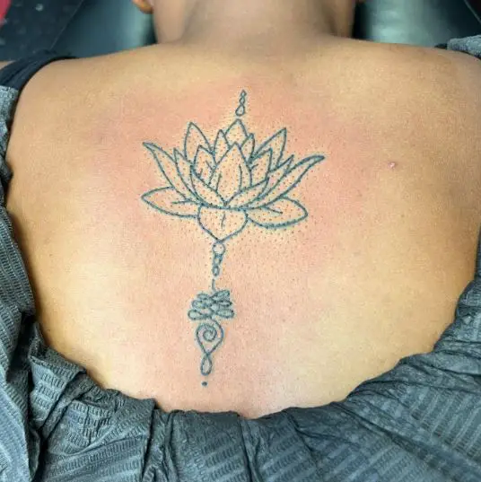 Blue Inked Lotus Tattoo On The Back
