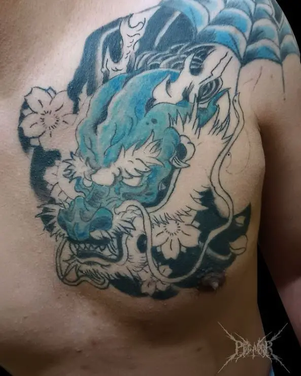 Blue demonic dragon tattoo on the chest