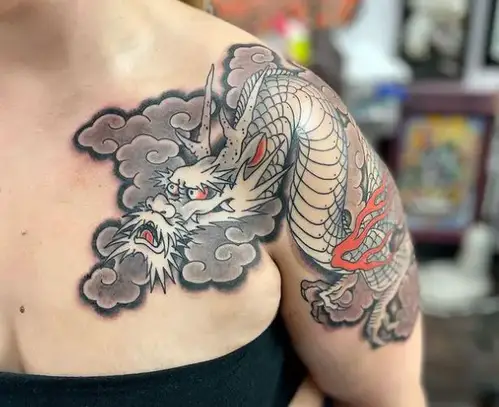 Dragon tattoo with clouds around it