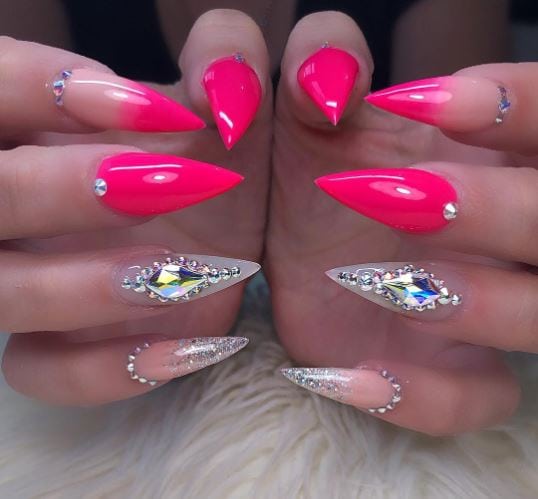 Hot pink stiletto nails with silver stones and glitter