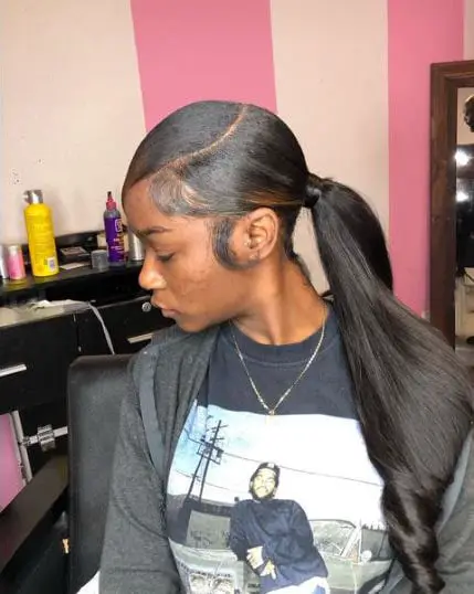Low ponytail hair with brown highlights at the front
