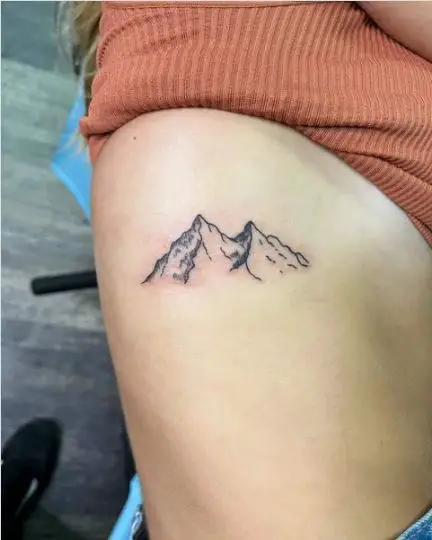 Mountain range tattoo on ribs