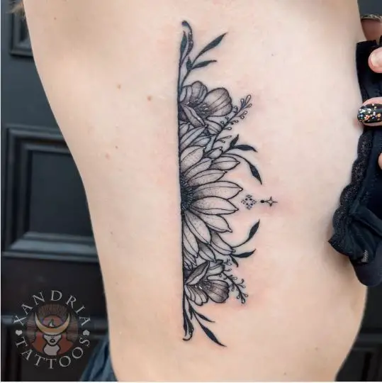 Rib floral piece tattoo