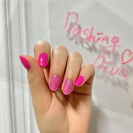 Short nails with glossy pink polish and glitter