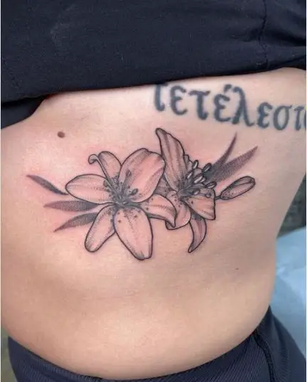 Simple lilies Rib Tattoo