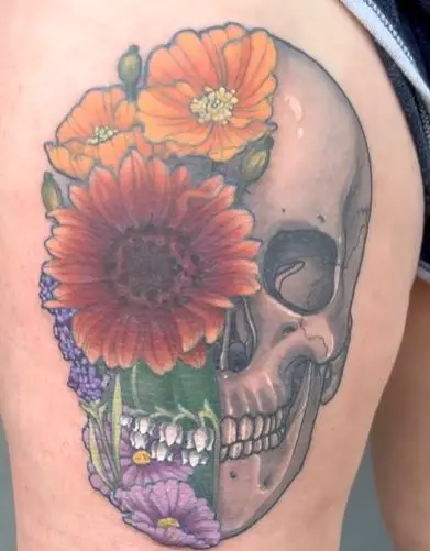 Skull & Wildflower thigh tattoo