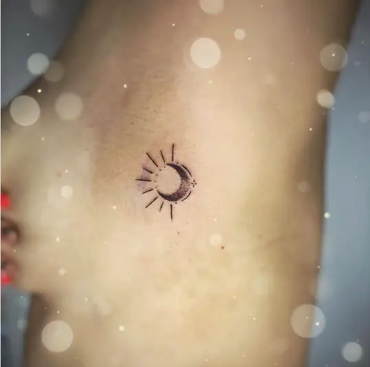 Tiny ornamental sun moon tattoo