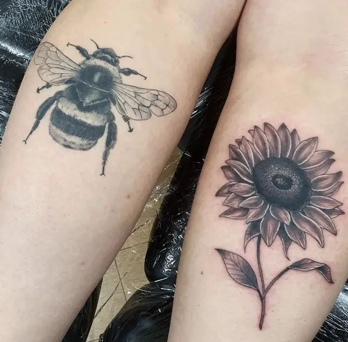 bee tattoo and a sunflower tattoo on both legs