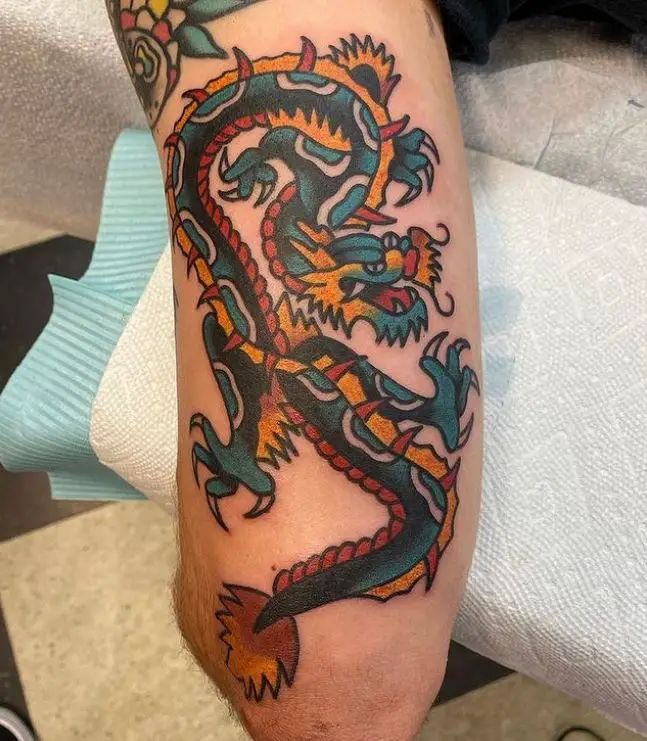 bicep tattoo with a colourful dragon