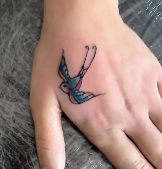 bird tattoo in colour on the hand