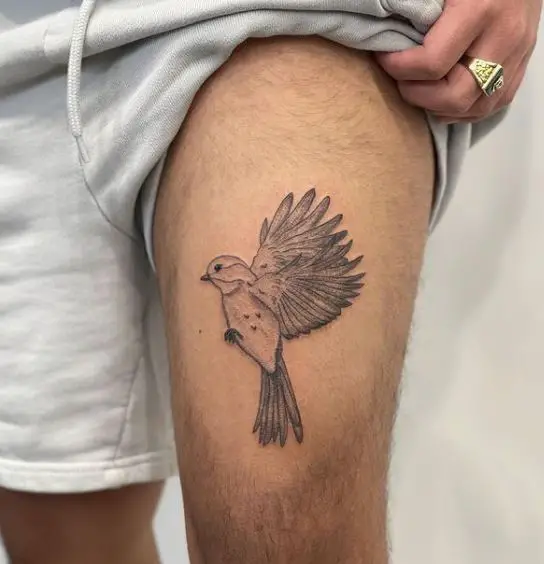 bird tattoo on the thigh