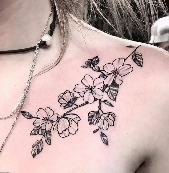 black and grey chest flower tattoo