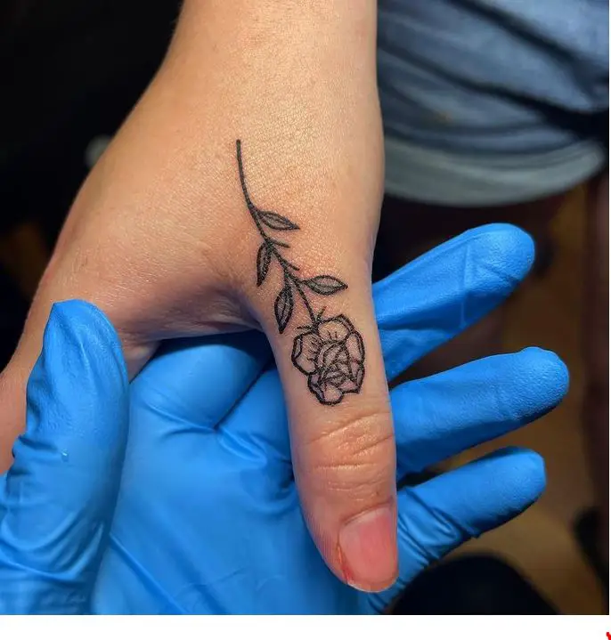 black rose tattoo on the thumb