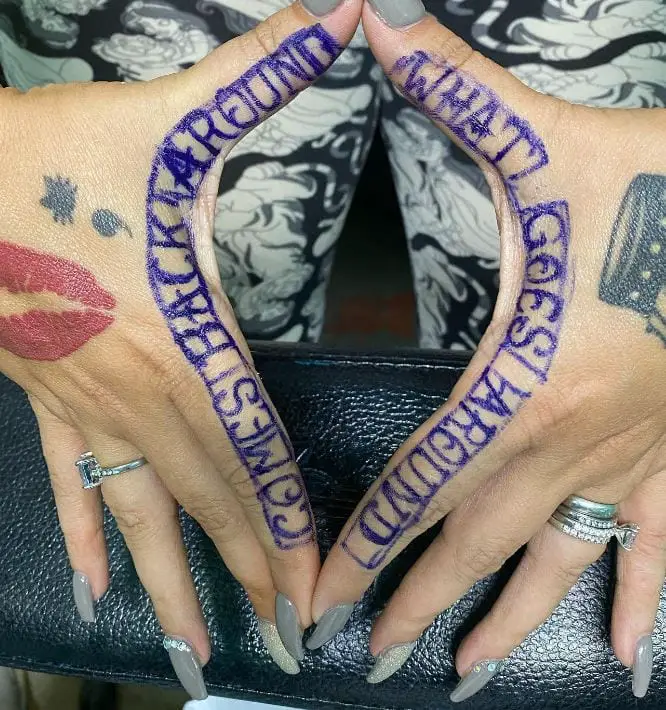 blue wording hand tattoo
