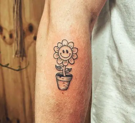cartoonish sunflower in a pot tattoo