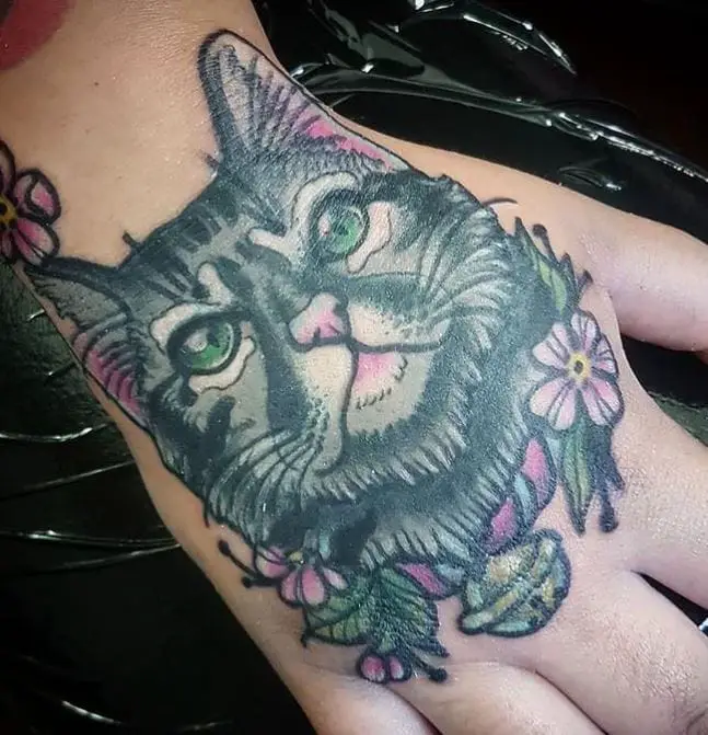 cat hand tattoo with some colour