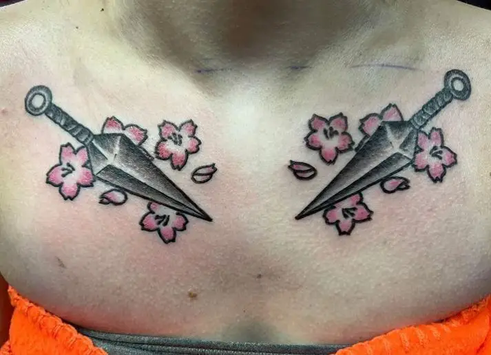 chest tattoo with two daggers
