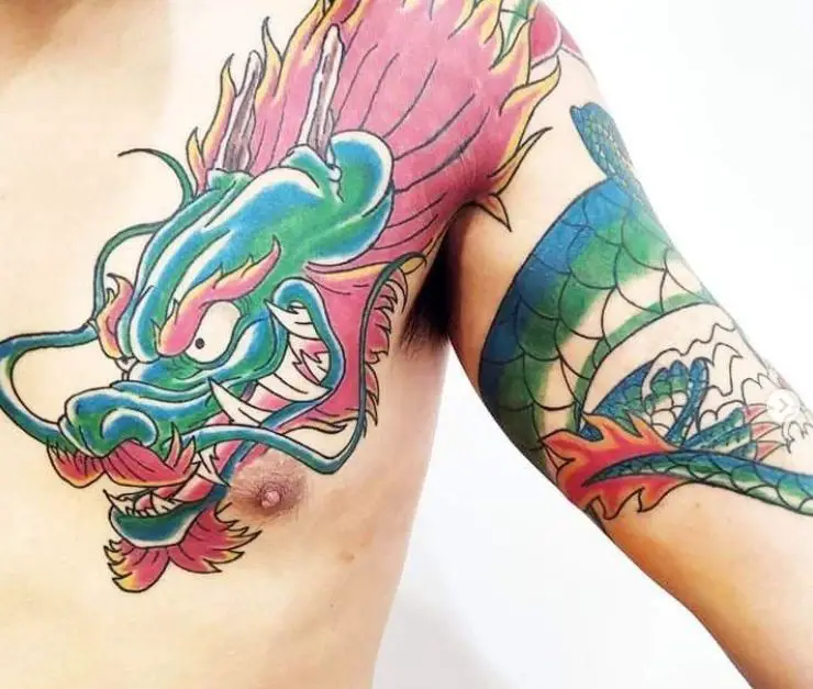 coloured dragon tattoo on the chest and shoulder