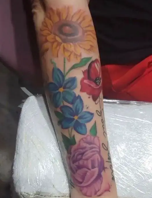 coloured floral tattoo on the arm