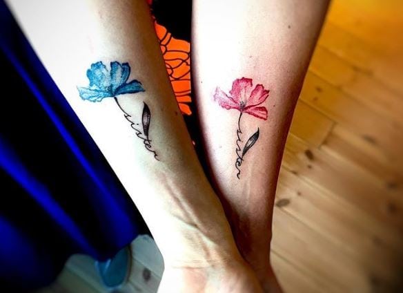 coloured matching sister tattoos